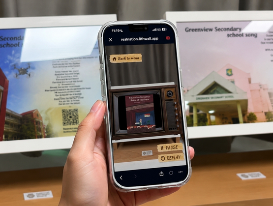 Student scanning AR marker to explore Loyang View Secondary School heritage gallery powered by qiksense.