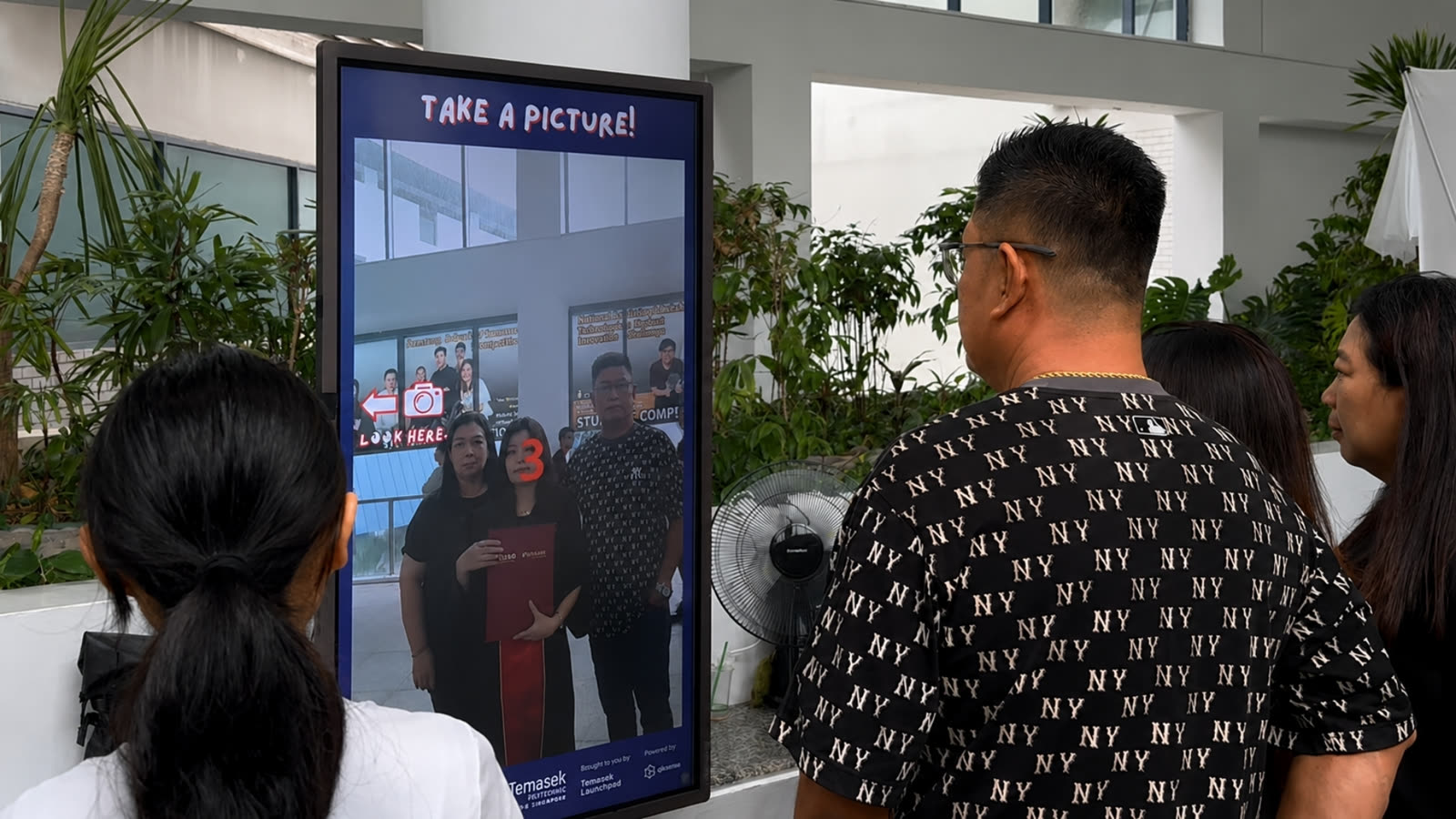 Graduates using Temasek Polytechnic AI caricature photobooth by qiksense — image 2