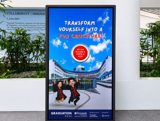 Temasek Polytechnic graduates and their families using an AI caricature photobooth powered by qiksense during Graduation Day 2026.