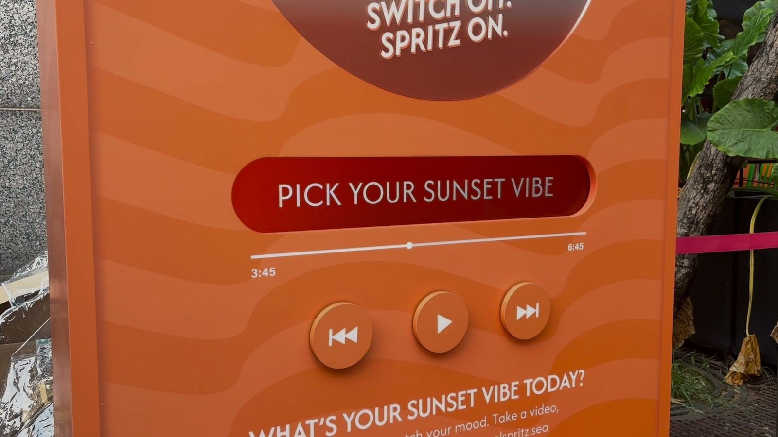 PICK YOUR SUNSET VIBE display with the previous, play and next buttons of the qiksense music player on the Sunset Vibe booth