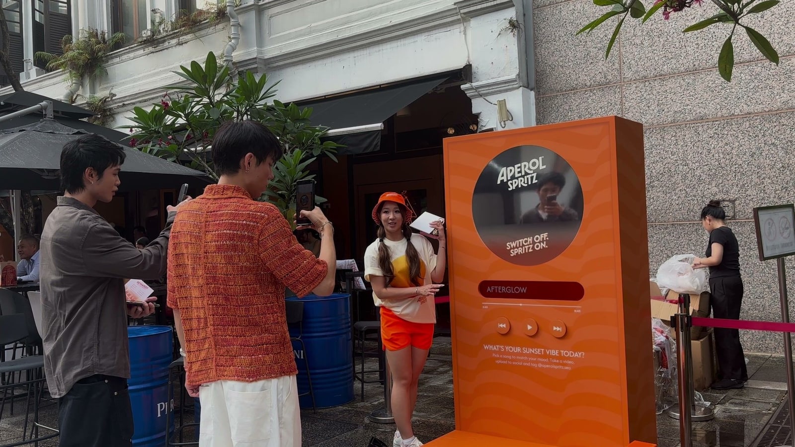 Guests filming the Sunset Vibe music booth by Popper Asia on Pekin Street, with its display and buttons powered by qiksense