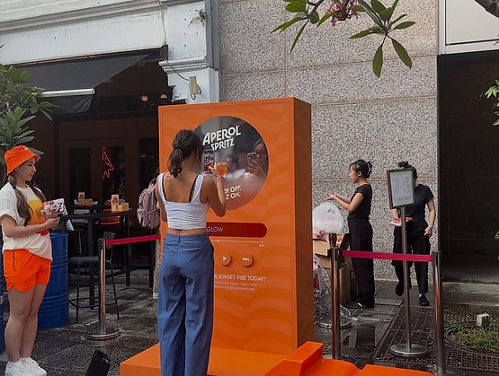 Guests at the Sunset Vibe music booth by Popper Asia on Pekin Street, with its display and buttons powered by qiksense