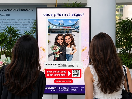 Graduates viewing their AI caricature on the Temasek Polytechnic AI photobooth screen built on qiksense