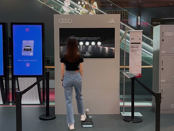 A player watching the start lights at the Lights Out Challenge by Popper Asia for Audi and adidas at Funan, with the game run on qiksense