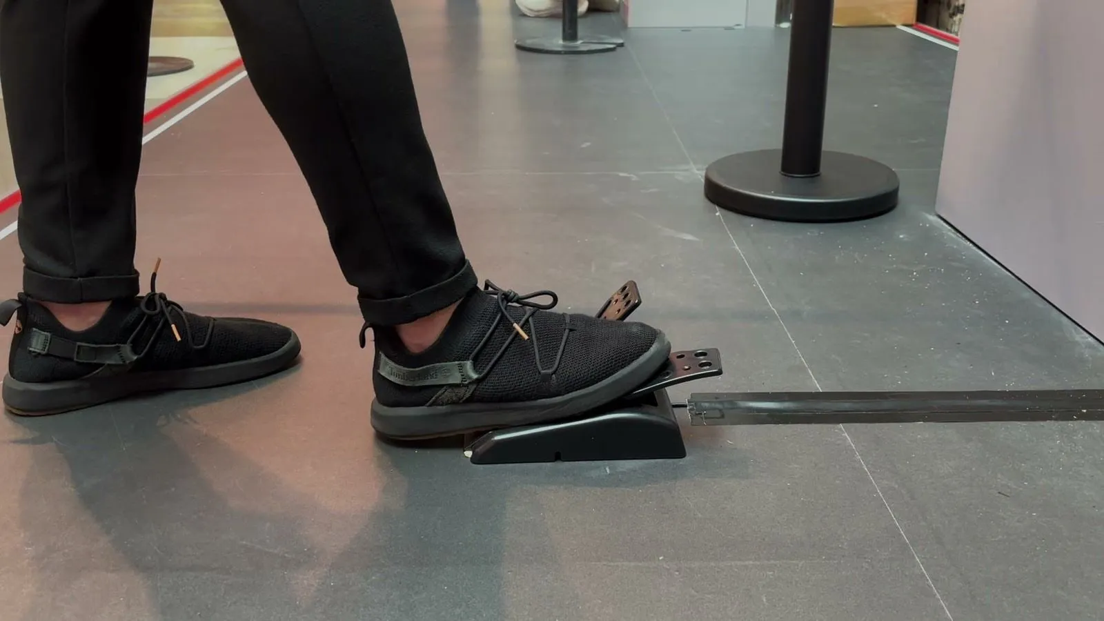 A player’s foot on the foot pedal in front of a Lights Out screen