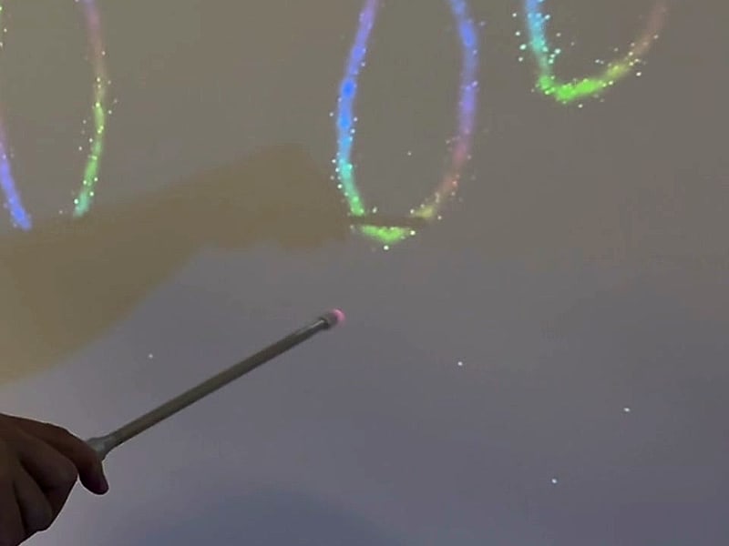 A hand drawing sparkling trails with the pointer