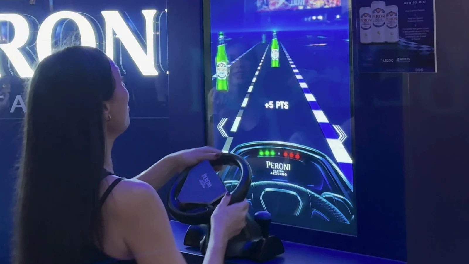A guest turning the racing wheel at the Peroni Speed Collector